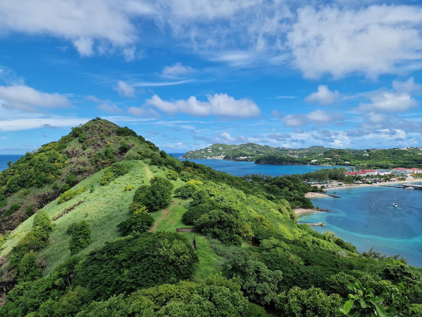 Stunning tropical landscape in St. Lucia with lush green hills overlooking crystal clear blue waters and coastline